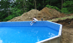 Notice that the pool does not require a concete footer or backfilling. This pool is sitting on top of the ground and is in the process of being filled with water.
