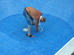 Once the liner is installed and the pool has only a few inches of water in the deep end, it's time to carefully and securely install the main drain ring in place with all screws. Then cut the liner from inside the drain ring to expose the drain, then install the main drain cover.